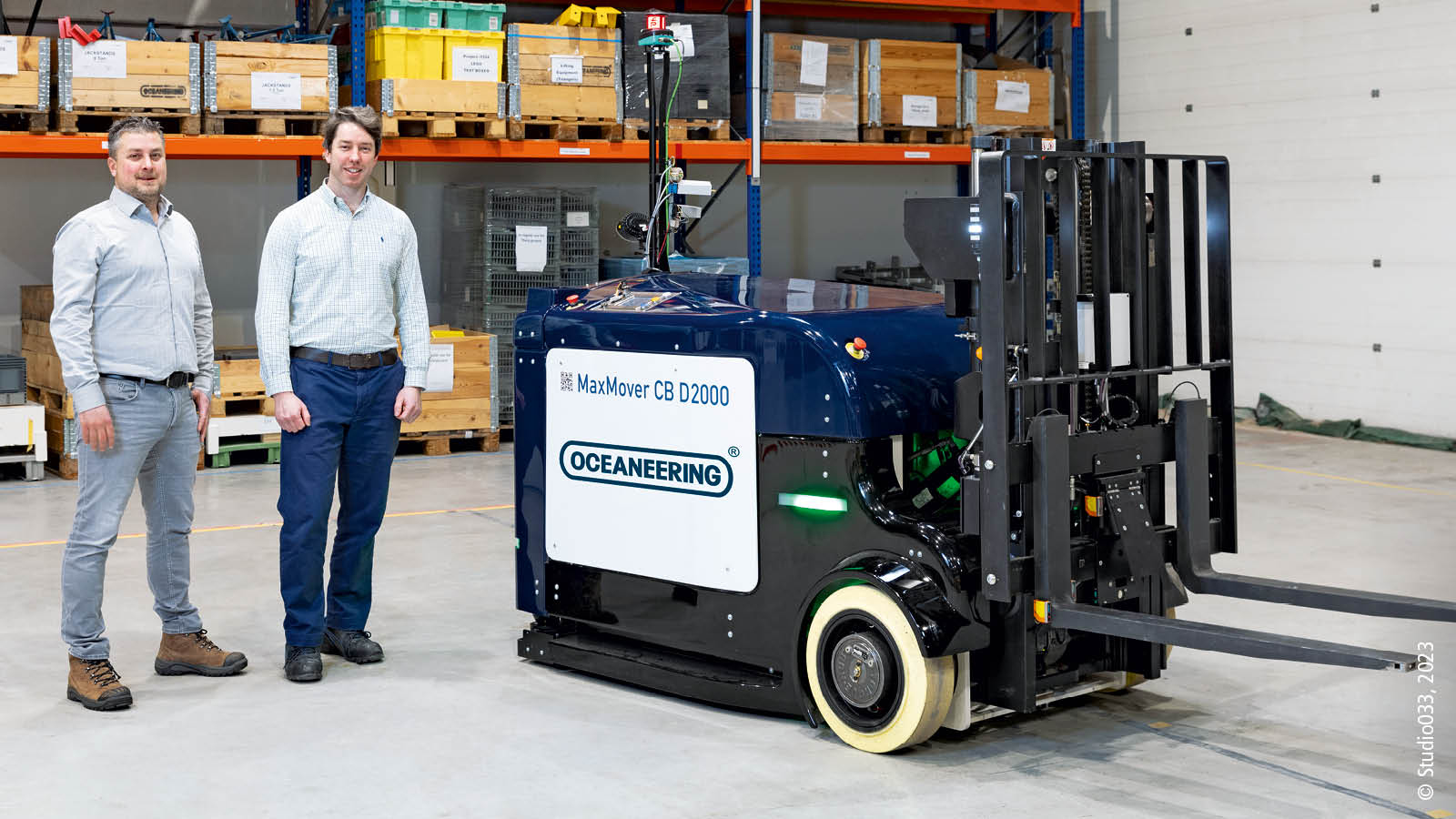 At the OMR office in The Netherlands: Dr. Gareth Jones (right), Manager of Technology for Oceaneering Mobile Robotics, and Stefan Dubbeldeman, Sales Engineer, Beckhoff Automation B.V., stand alongside a MaxMover™ CB D 2000 counterbalance forklift.
